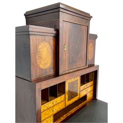 Early to mid-19th century figured mahogany Continental secrétaire à abattant, stepped top fitted with single cupboard, inlaid with oval figured amboyna panels, the fall front inlaid with shell motif enclosing a satinwood interior fitted with cupboard, drawers, and pigeon holes, three long drawers below, on square tapering feet