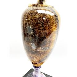 Early 19th century and later Blue John urn, Winnats one vein, of ovoid form with integrated cover and ball finial, upon a spreading circular base, and square stepped black lacquered base, H34.5cm