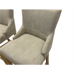 Pair of light oak bar stools, upholstered in beige fabric