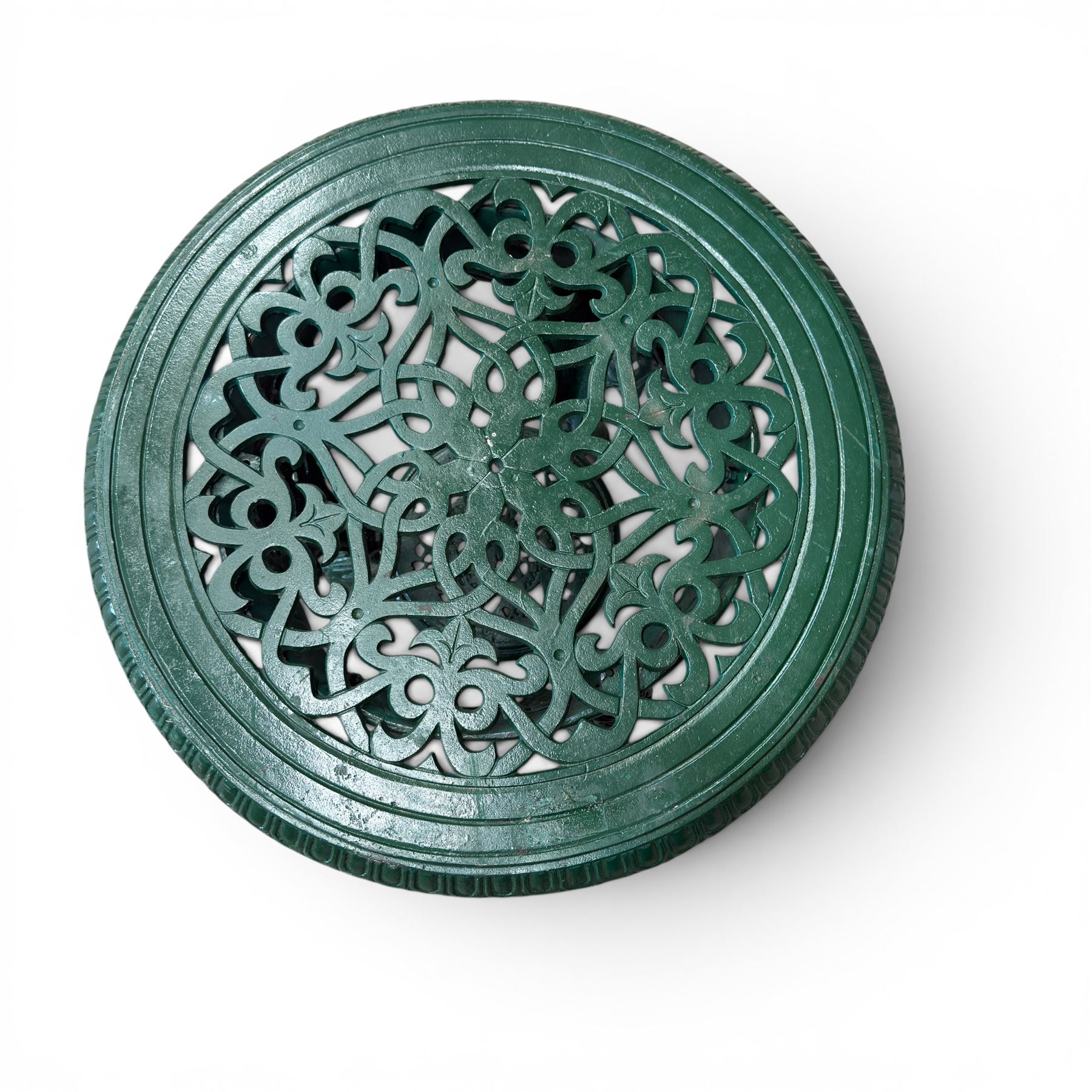Painted cast iron garden table, the circular pierced top with foliate decoration and egg-and-dart rim, raised on three cloven hoof supports with classical female mask knees, united by pierced undertier, in green-painted finish