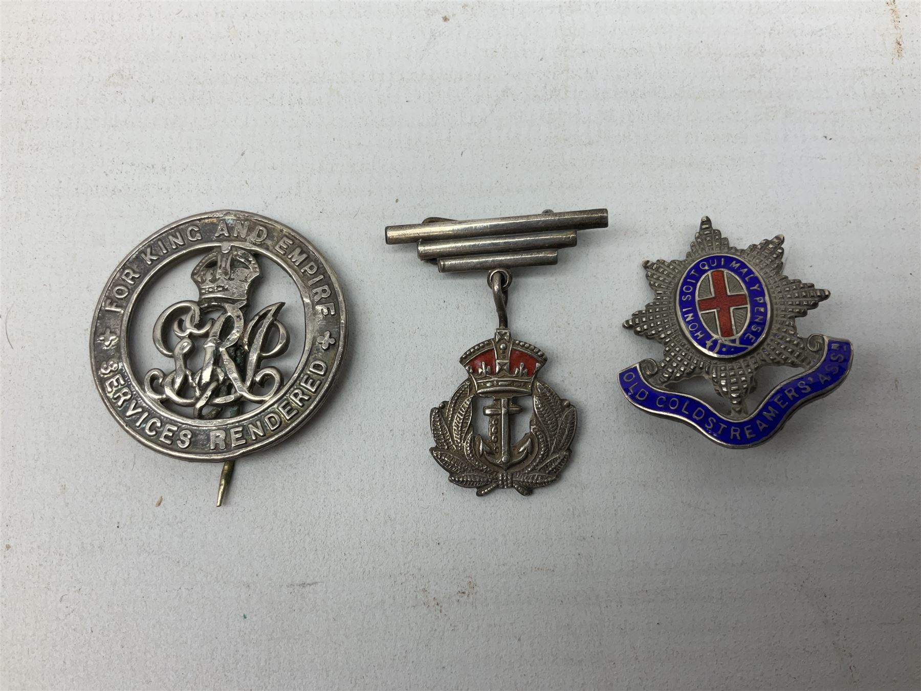 Military metal lapel and pin back badges to include stamped silver Old Coldstreamers Association example and another stamped silver badge, Royal Warwickshire examples, Glamorgan Yeomanry etc