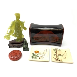 A Chinese translucent green hardstone figure, modelled as Guanyin, raised upon a wooden base, figure H19cm, together with a smaller carved hardstone figure of a Tibetan Buddha, a pair of Japanese plates, with character mark, a Chinese lacquered pillow, and a small Cinnabar style box.