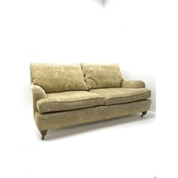 Duresta two seat sofa, upholstered in pale gold fabric, Egyptian pattern, turned supports and brass casters (W172cm, D114cm, H77cm), two matching Duresta armchiars (W84cm, D102cm, H80cm)