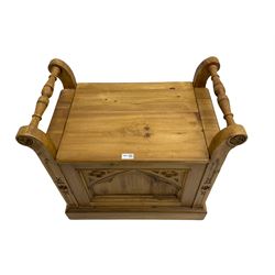 Gothic style pine stool with hinged box seat, decorated with flower head motifs, plinth base