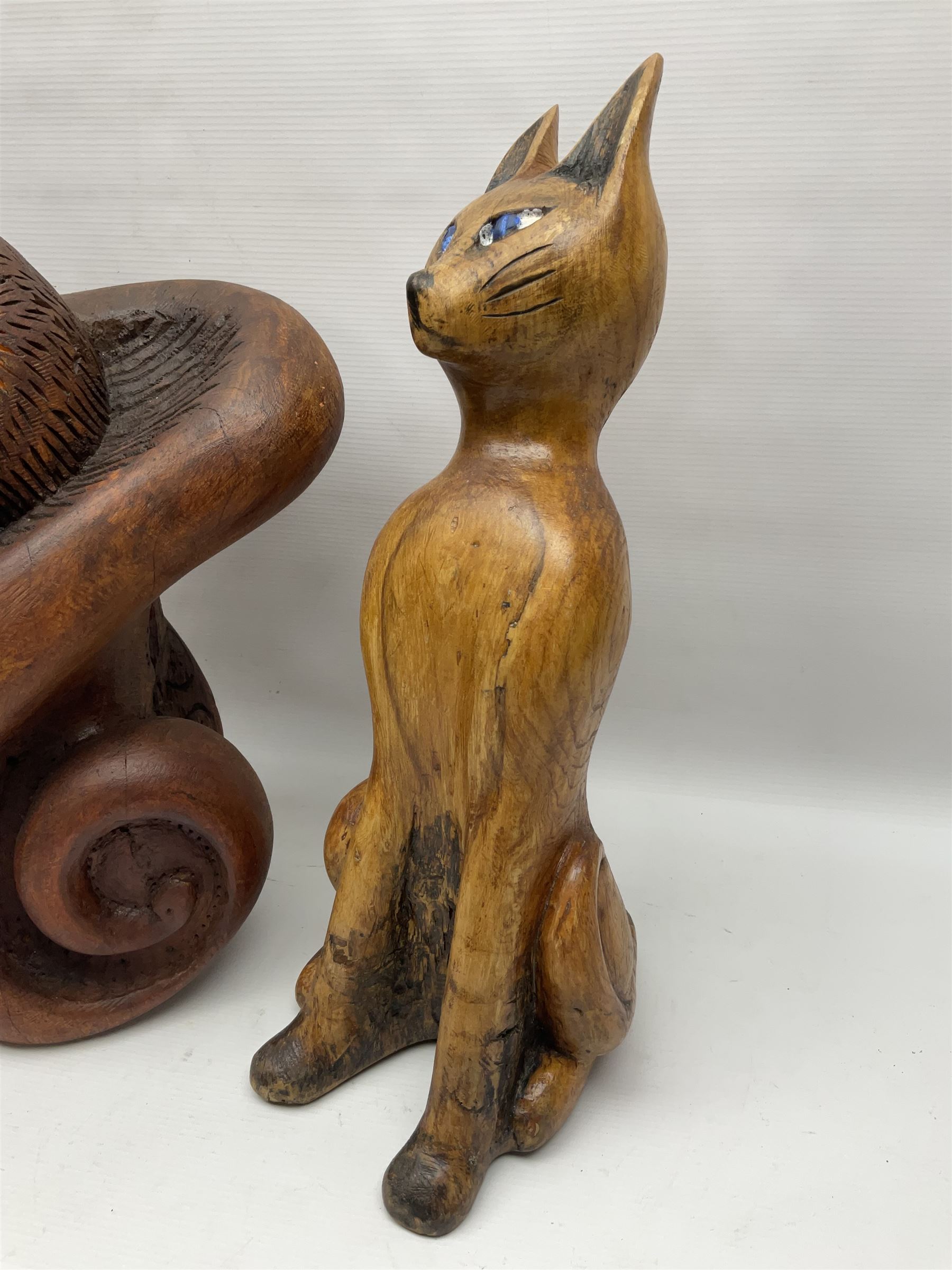 Helen Skelton (British 1933 – 2023): Three carved wooden abstract sculptures, each modelled as a cat, with carved or painted features, largest H63cm. Born into an RAF family in 1933 in Kent and travelled the world extensively during her childhood. After settling in Bridlington, Helen immersed herself in painting, textiles, and wood sculpture, often inspired by nature's beauty. Her talent was showcased in a one-woman show at Sewerby Hall and recognised with the sculpture prize at Ferens Art Gallery in 2000. Sadly, Helen’s daughter passed away from cancer in 2005. This loss inspired Helen to donate her sculptures to Marie Curie upon her passing in 2023.