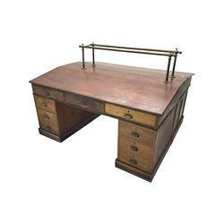 Large late 19th century mahogany double partners or banking desk, the sloped top fitted with brass railings, fitted with nine drawers on each side, on plinth base
