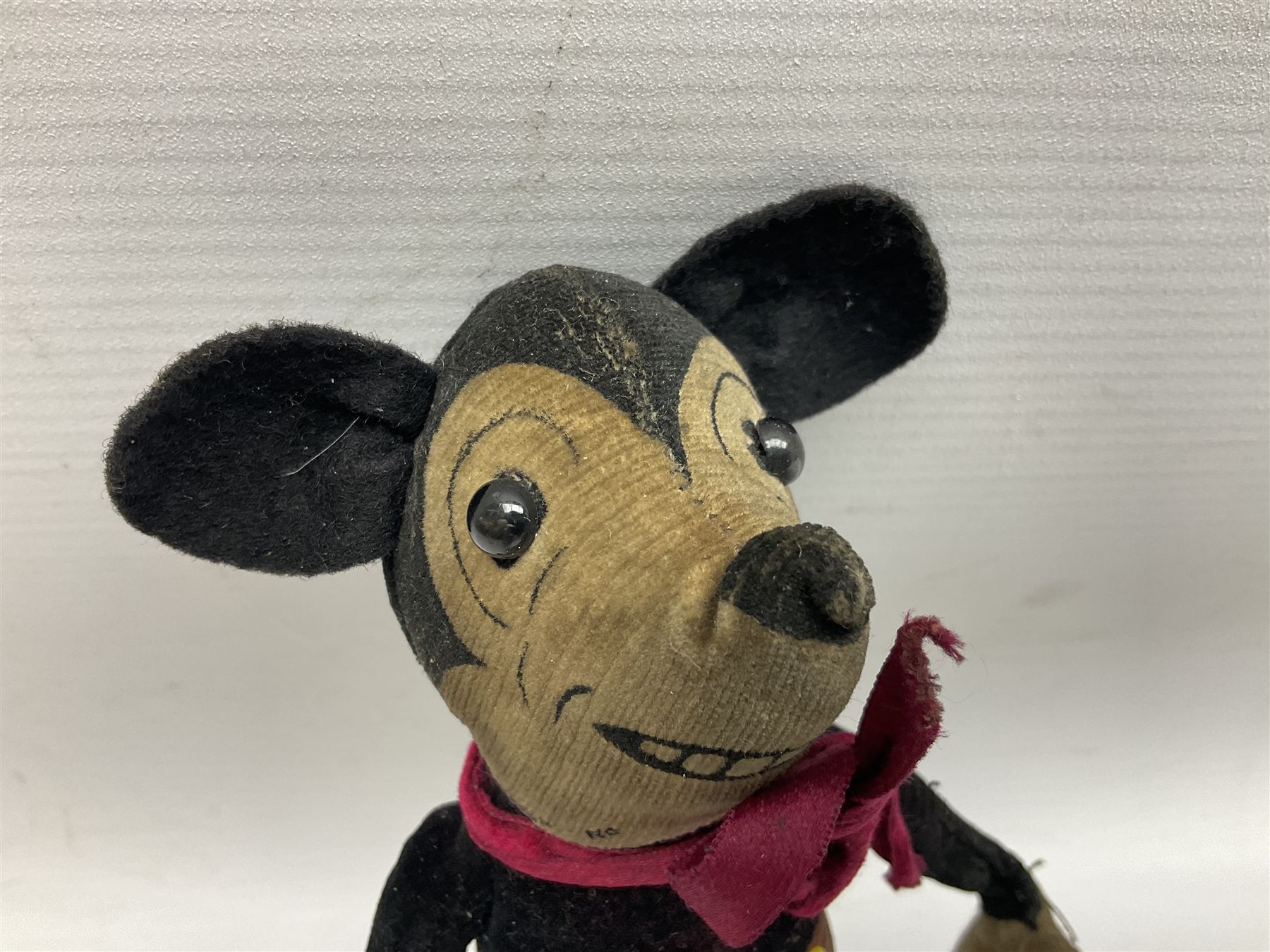 Deans Rag Book Mickey Mouse soft toy, circa 1930's, black velveteen head and body, with cream face and hands, red shorts and yellow felt shoes, marked Reg. No. 750811 to neck H19cm