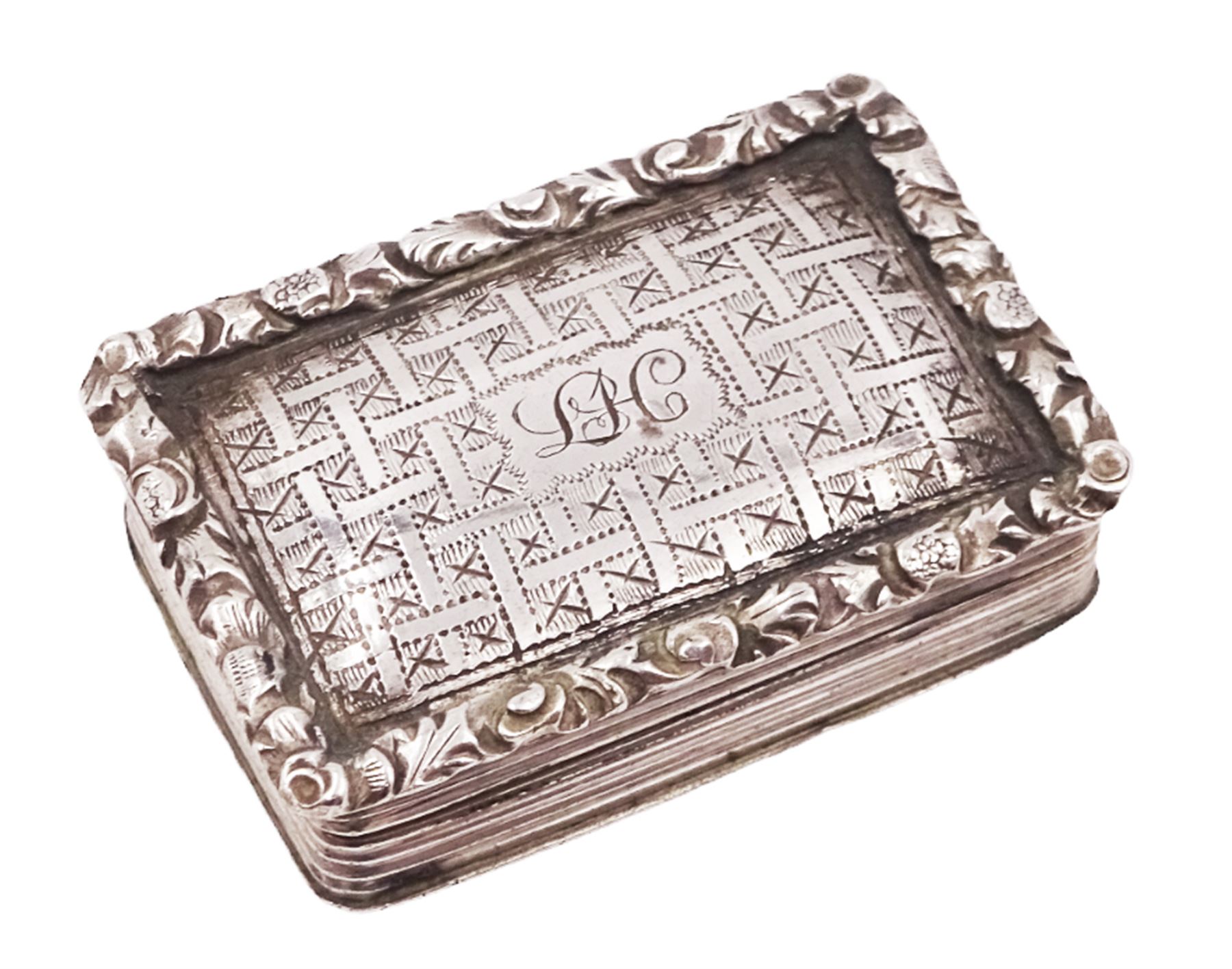 George III silver vinaigrette, of typical rectangular form, with raised foliate rim and engine turned decoration, with banded sides and foliate pierced engraving to gilt interior, hallmarked Birmingham 1797, maker's mark TS, L3cm