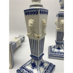 Set of four late 20th century Royal Copenhagen blue fluted candlesticks, of Neoclassical form, the tapering stems with lion masks and husk swag detail, with printed and painted marks beneath, H23cm