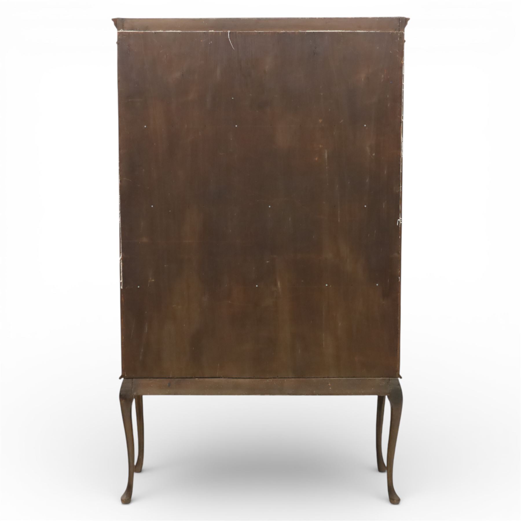 20th century Edwardian style mahogany display bookcase cabinet, the moulded cornice above two lancet glazed doors enclosing a shelved interior, the lower sections with oval inlaid fan decoration, supported on shaped cabriole legs