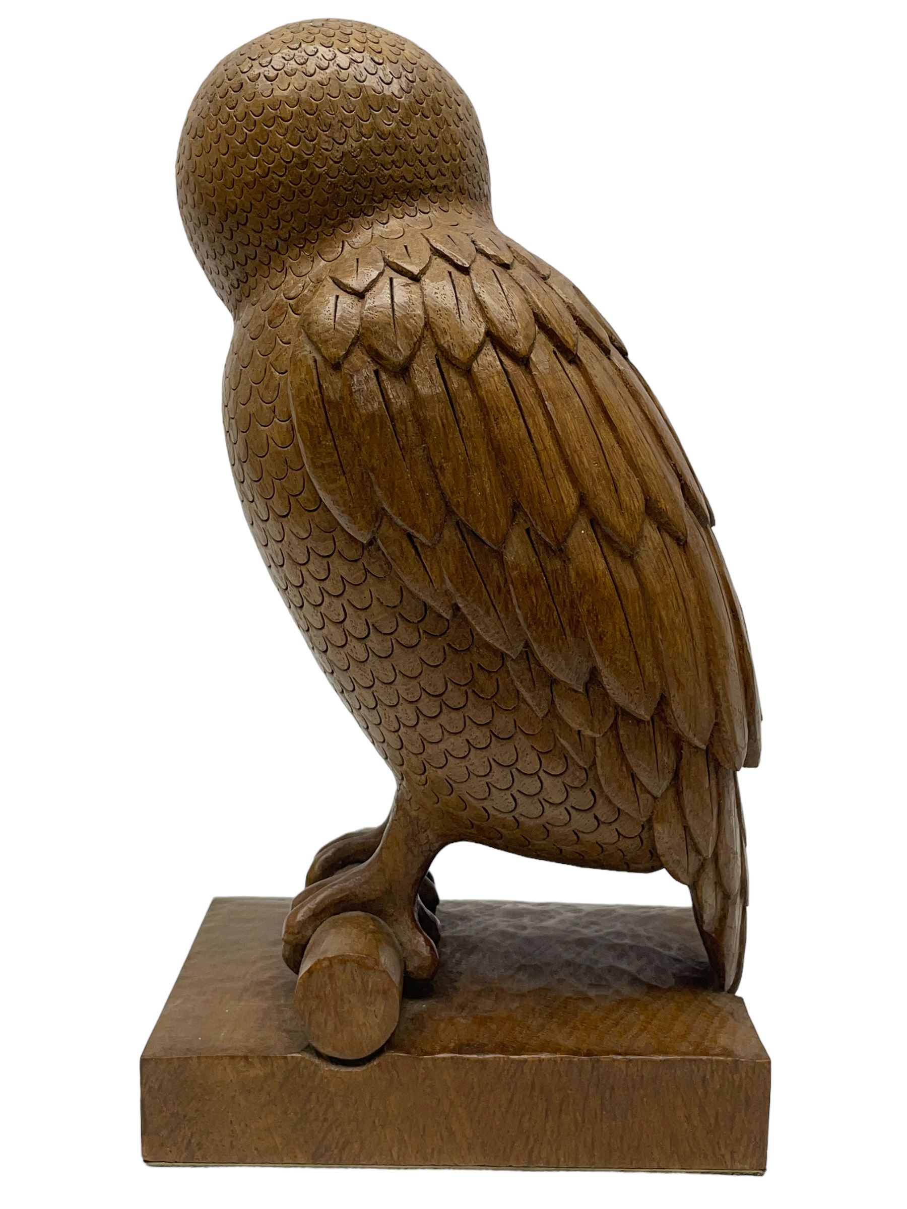 Acornman - carved oak owl perched on branch, on tooled block plinth carved with acorn signature, by the workshop of Alan Grainger, Brandsby (carved by Norman Darnley)