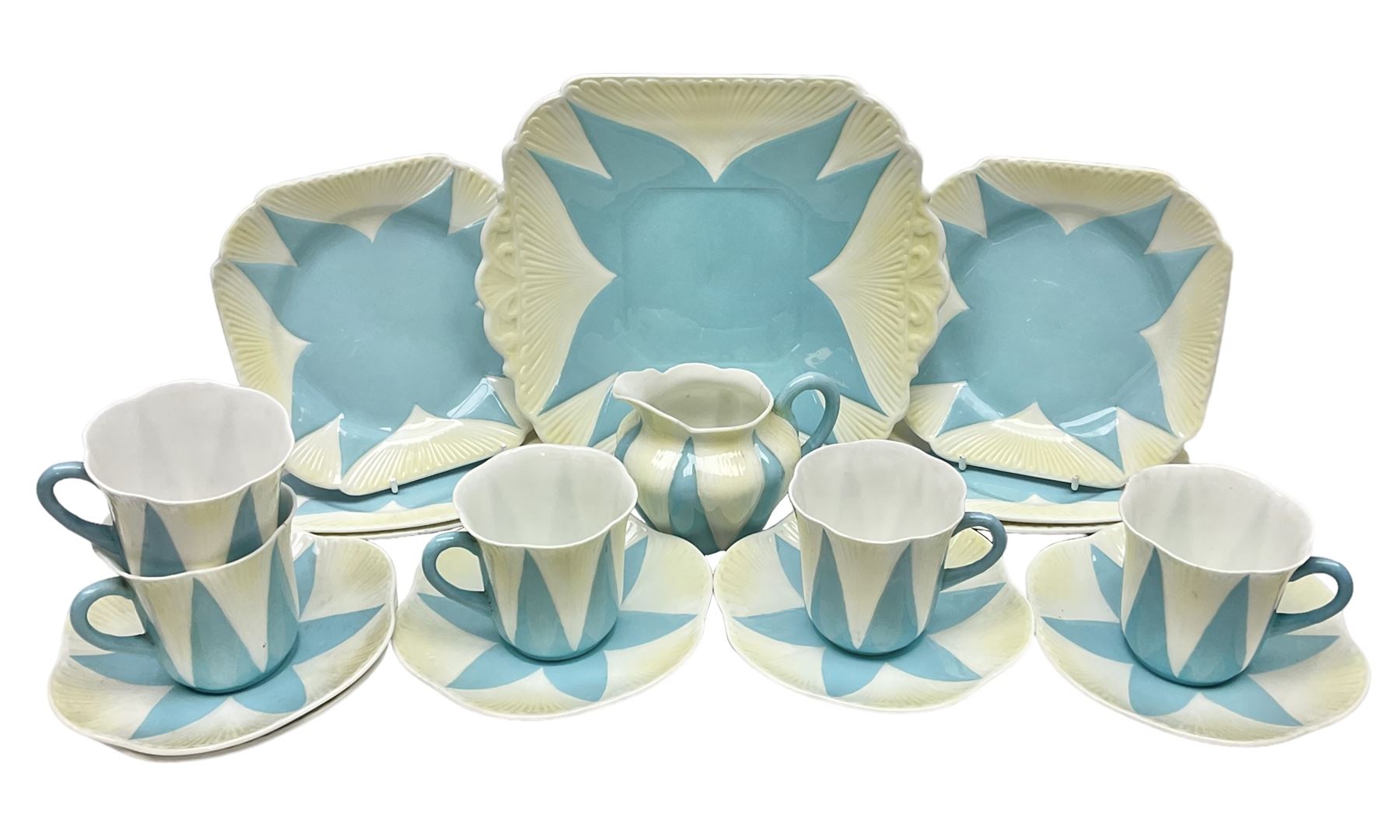 Shelley Dainty pattern tea wares, of lobed form with blue star decoration on merging white and yellow ground, comprising five teacups, five saucers, six tea plates, milk jug and cake plate, all with printed green mark beneath, some with painted pattern no 11770