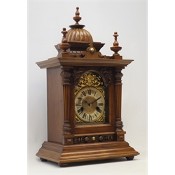  Early 20th century walnut mantel clock, architectural case, gadroon dome top with turned finials, single bevel glazed door with tapering reeded columns, stepped ogee base, twin train movement striking the hours and half on coil, H52cm  
