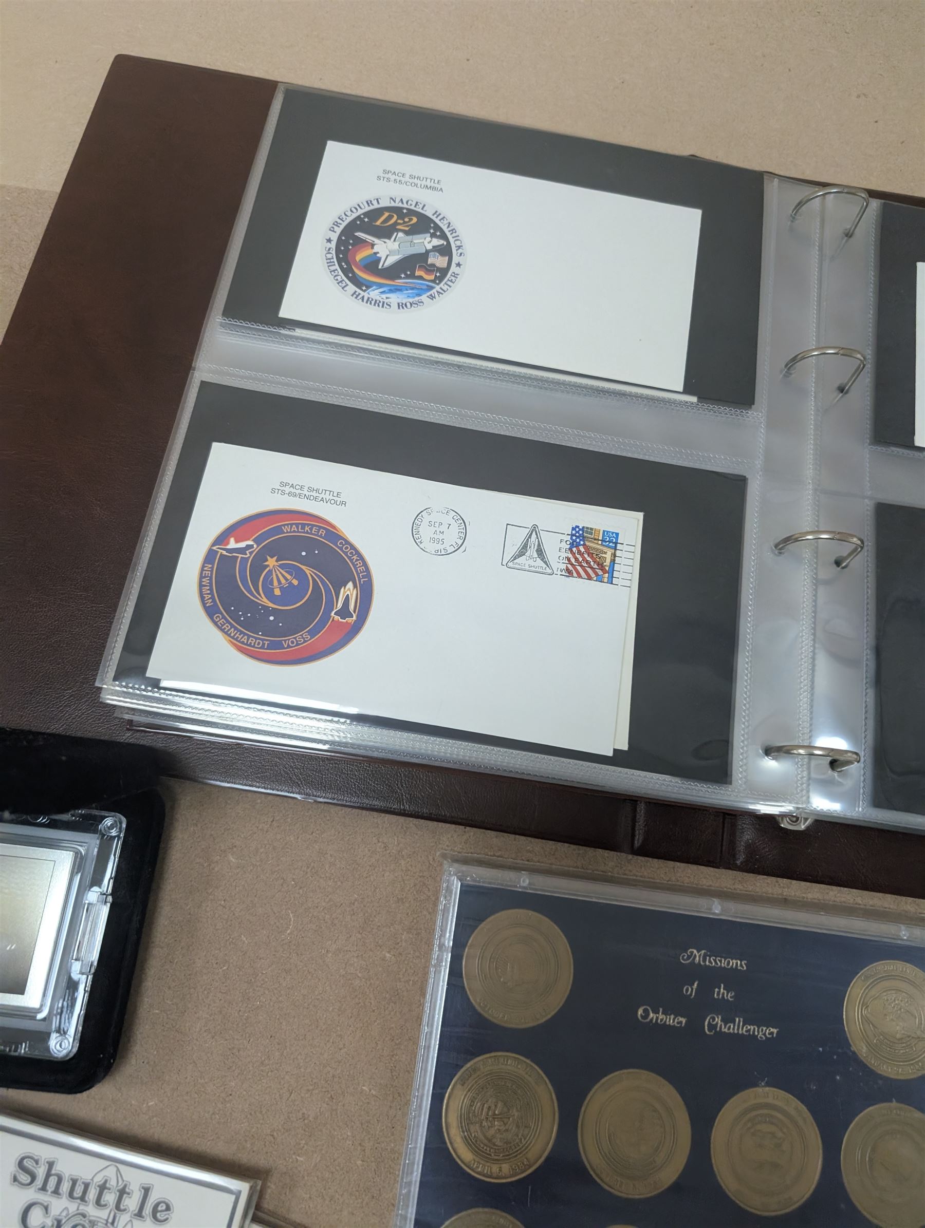 Nasa Space Shuttle program commemorative items, including album of stamp covers, telephone cards, five Shuttle Crew Emblem Collector's Series medallions, Maiden Flights bronze medallions, Missions of the Orbiter Challenger set of medallions and Apollo series medallions