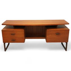 R Bennett for G Plan - mid-20th century teak 'Quadrille' desk or dressing table,  shaped platform rectangular top above rectilinear open base above four drawers with sculpted handles, on rectangular frame supports 