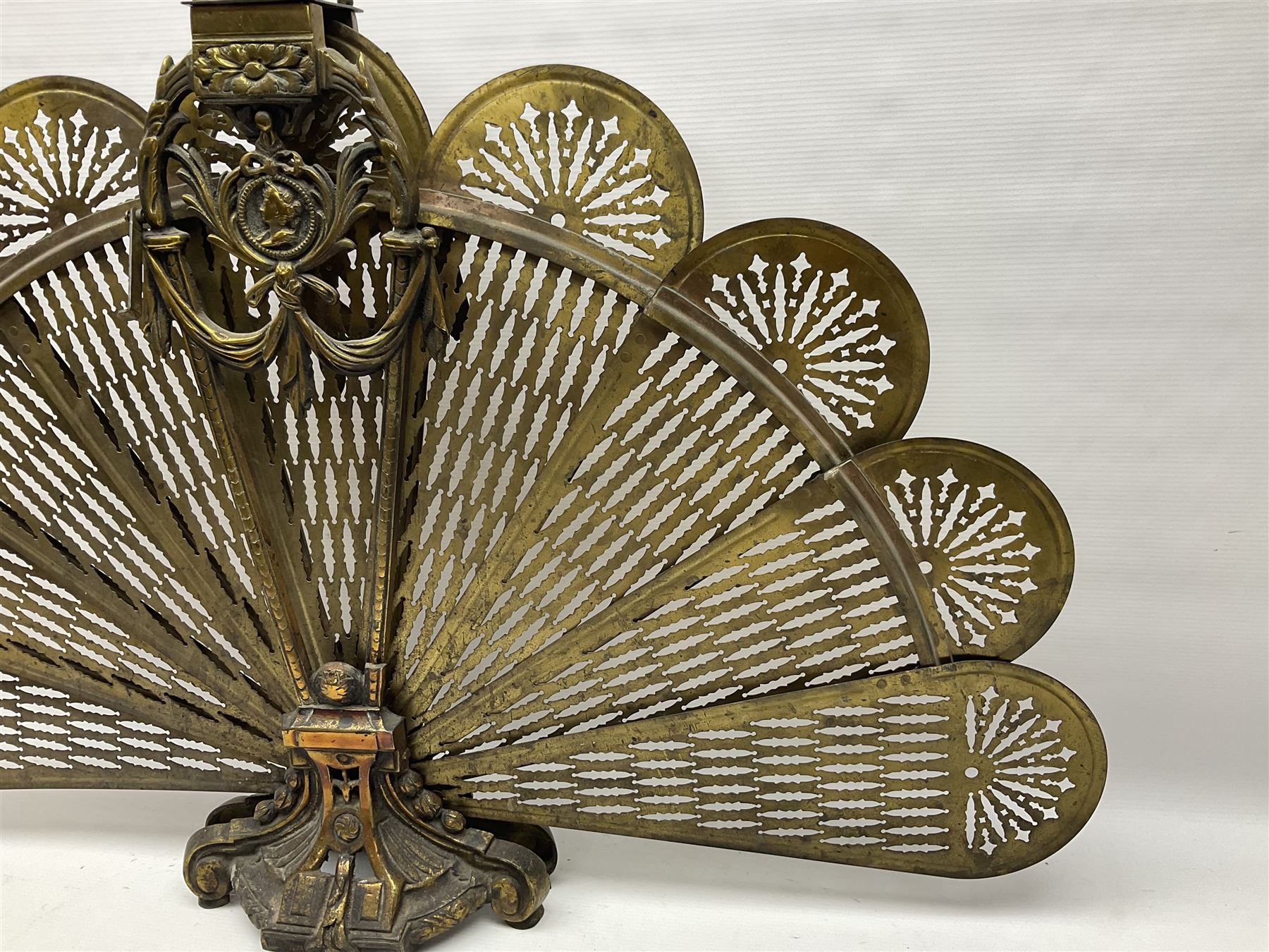 Pierced brass peacock style folding fire screen, with urn finial, H65.5cm