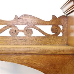 Maple & Co. - Arts & Crafts oak dresser with stained glass cupboard, raised section with pierced pediment above a mirrored back, with a stained glass fronted cupboard with fixed shelf, single long drawer, above a pair of fielded panels, with open recess above a short drawer, raised above a full length undertier with turned supports