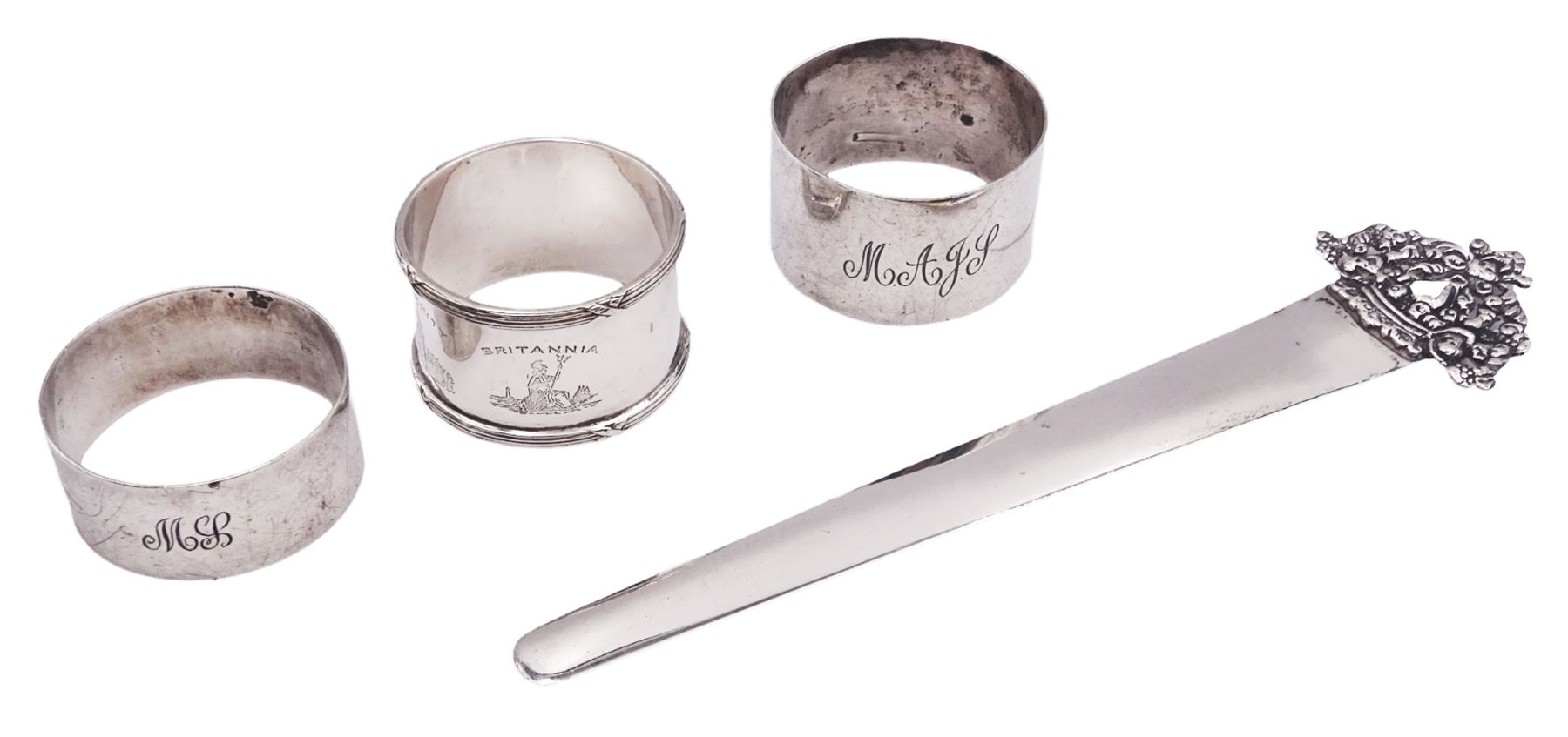 Edwardian silver page marker, with foliate terminal, hallmarked Stuart Clifford, London 1901, L18cm, together with three 20th century century silver napkin rings, to include one example of circular form with reed and ribbon border, hallmarked James Dixon & Sons Ltd, Sheffield 1936, approximate total weight 3.65 ozt (113.4 grams)