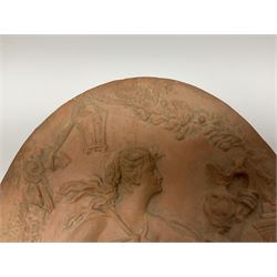 Pair of 19th century classical terracotta relief wall plaques depicting the goddess Hygeia and another goddess, seated holding an ewer, each of oval form, indistinctly signed, each stamped Ferreira verso, H42cm, W30cm