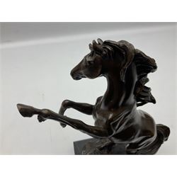 Bronze figure, modelled as a rearing horse, upon a rectangular black marble base, H27cm