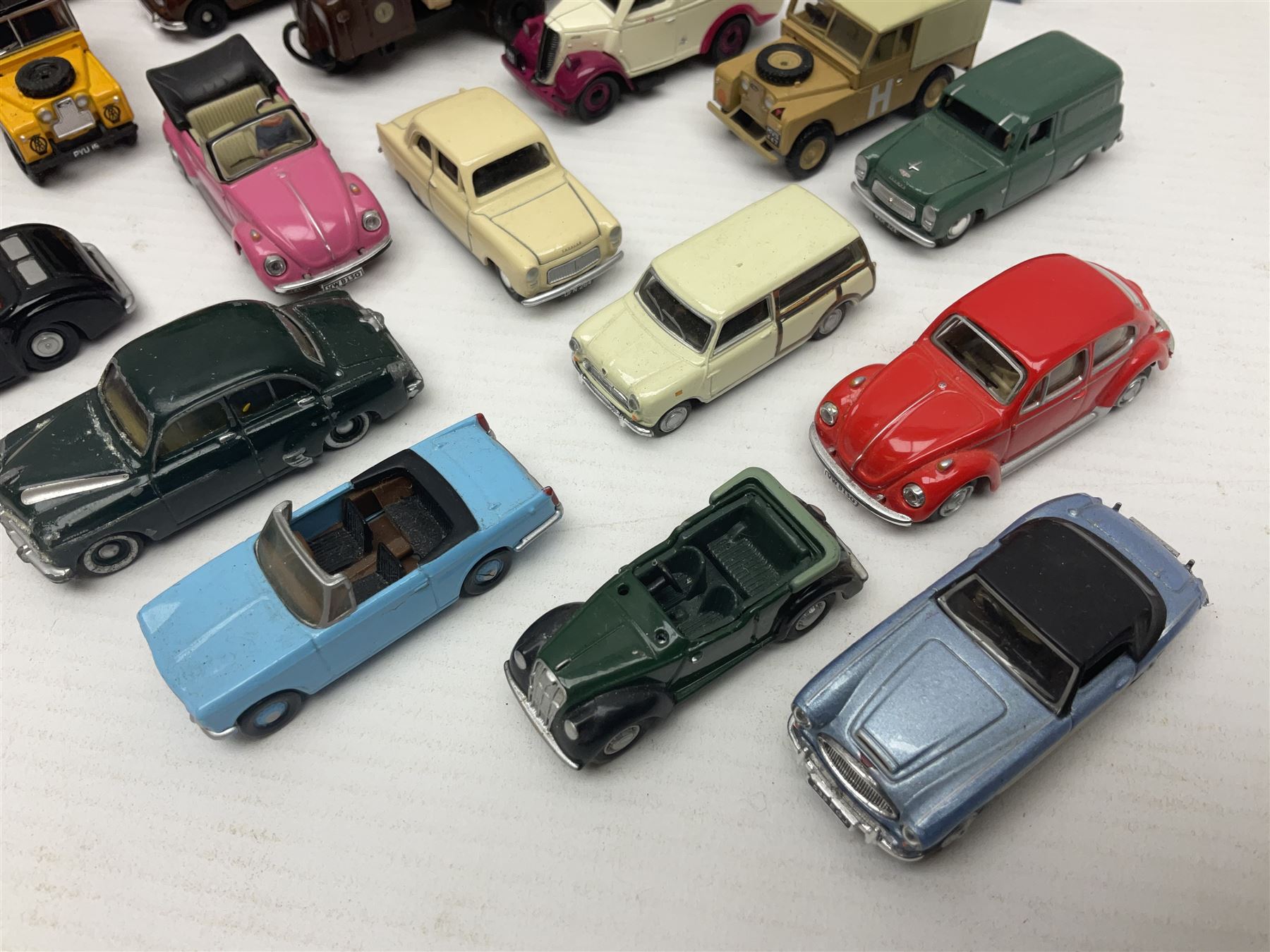 Over forty 1:76 scale die-cast models of cars and commercial vehicles; some boxed; and eight small scale models of motorcycles; all unboxed