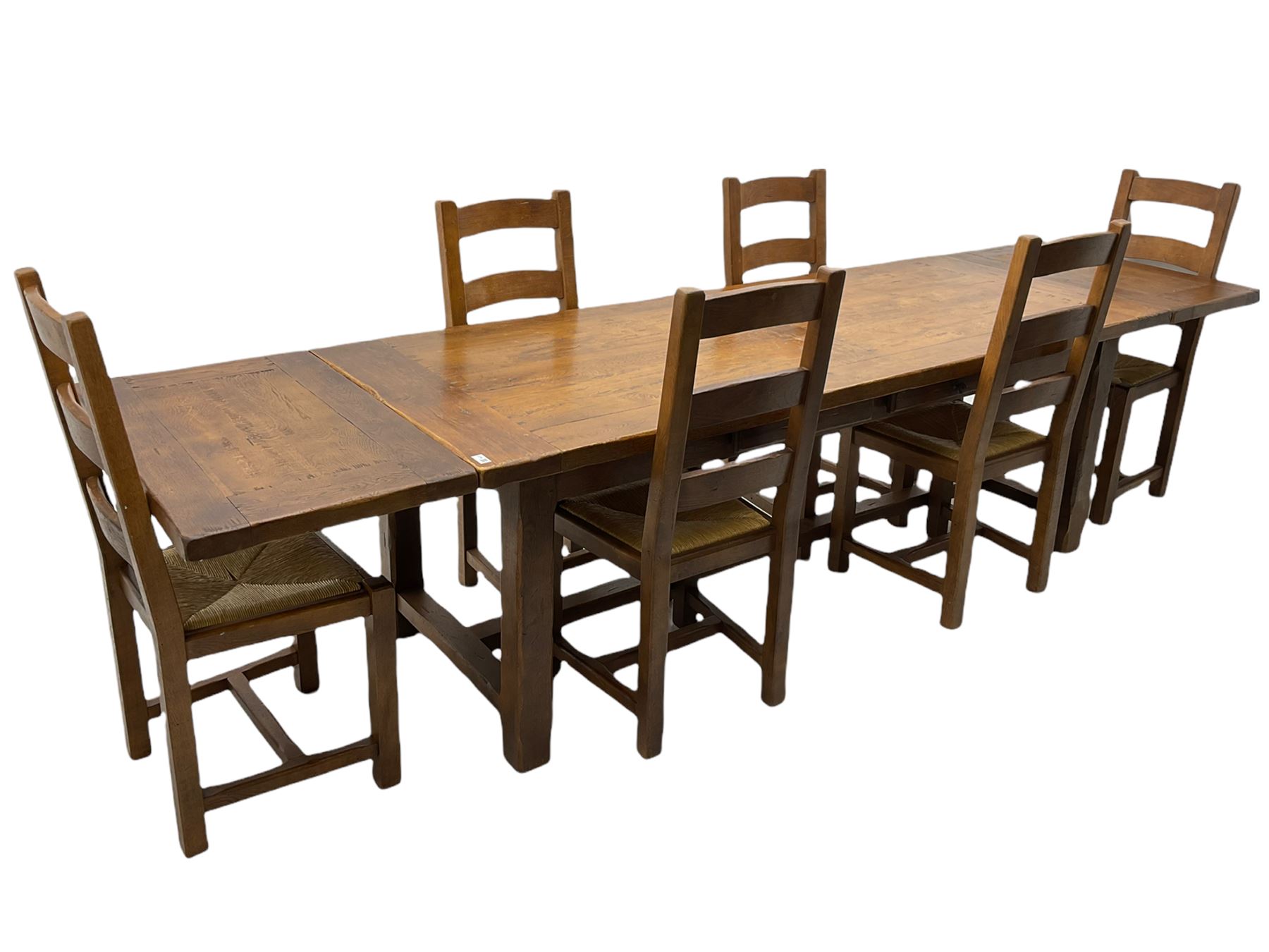 Antix French oak dining table with two leaves, two frieze drawers;, and six ladder back chairs with rush seats