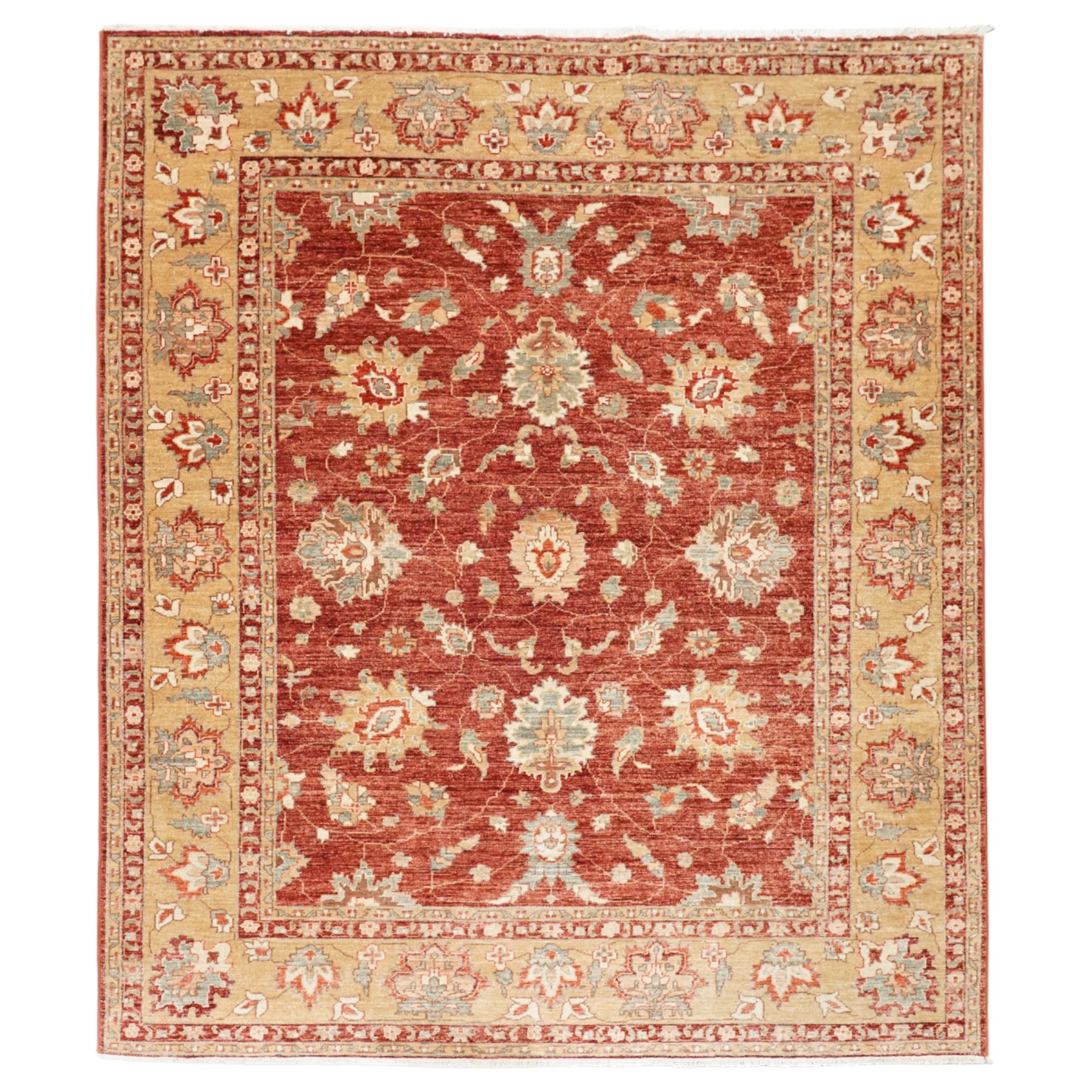 Persian Chubi Oushak style revival hand-knotted carpet, madder red field decorated with large-scale stylized palmettes and floral sprays framed by a broad pale golden border with simplified foliate motifs and multiple guard stripes