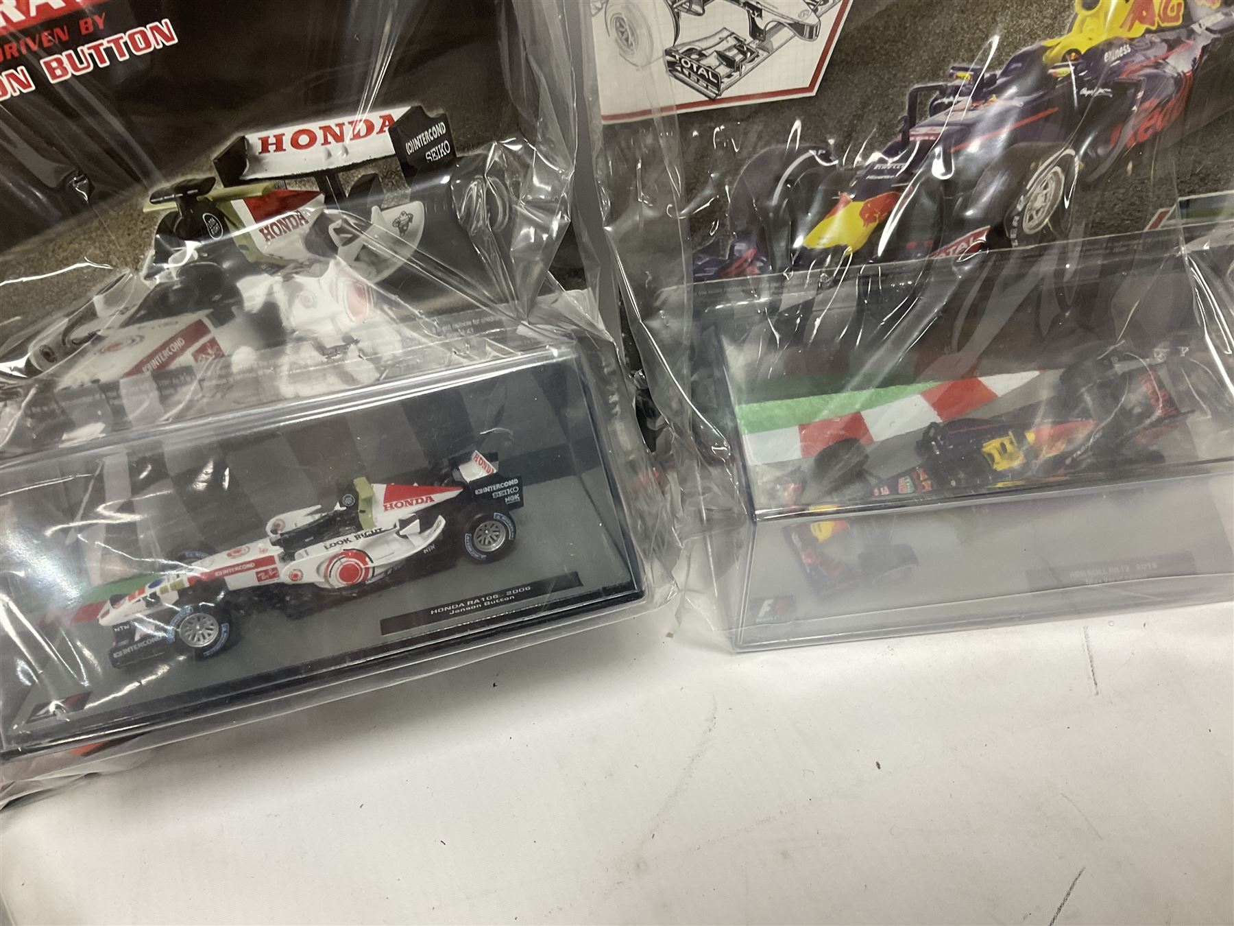 Panini Formula 1 The Car Collection - twelve die-cast models including ten in unopened packaging with periodical; all models in plastic display boxes; and eight other boxed die-cast models of racing cars by Corgi, Onyx, Classico, Minichamps etc (20)