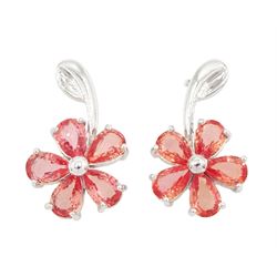 Pair of 18ct white gold padparadscha sapphire flower head stud earrings, each stem suspend...