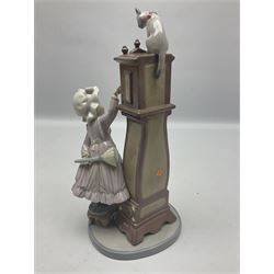 Lladro figure, Bedtime, modelled as a young girl reaching for her pet cat upon grandfather clock, sculpted by Vincente Martinez, with original box, no 5347, year issued 1986, year retired 1998, H28cm