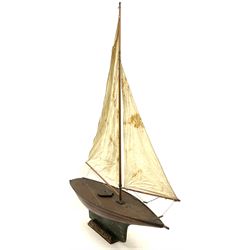 Large Victorian pond yacht, the planked hardwood hull with large lead weighted keel and working rudder, simulated planked deck and single mast with original sails; on later scratch-built wooden stand L117cm H151cm