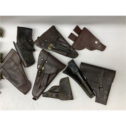 Leather pistol holsters with magazine compartments, other leather holsters, cartridge and other belts, walking cane, baton numbered '428 0717' etc
