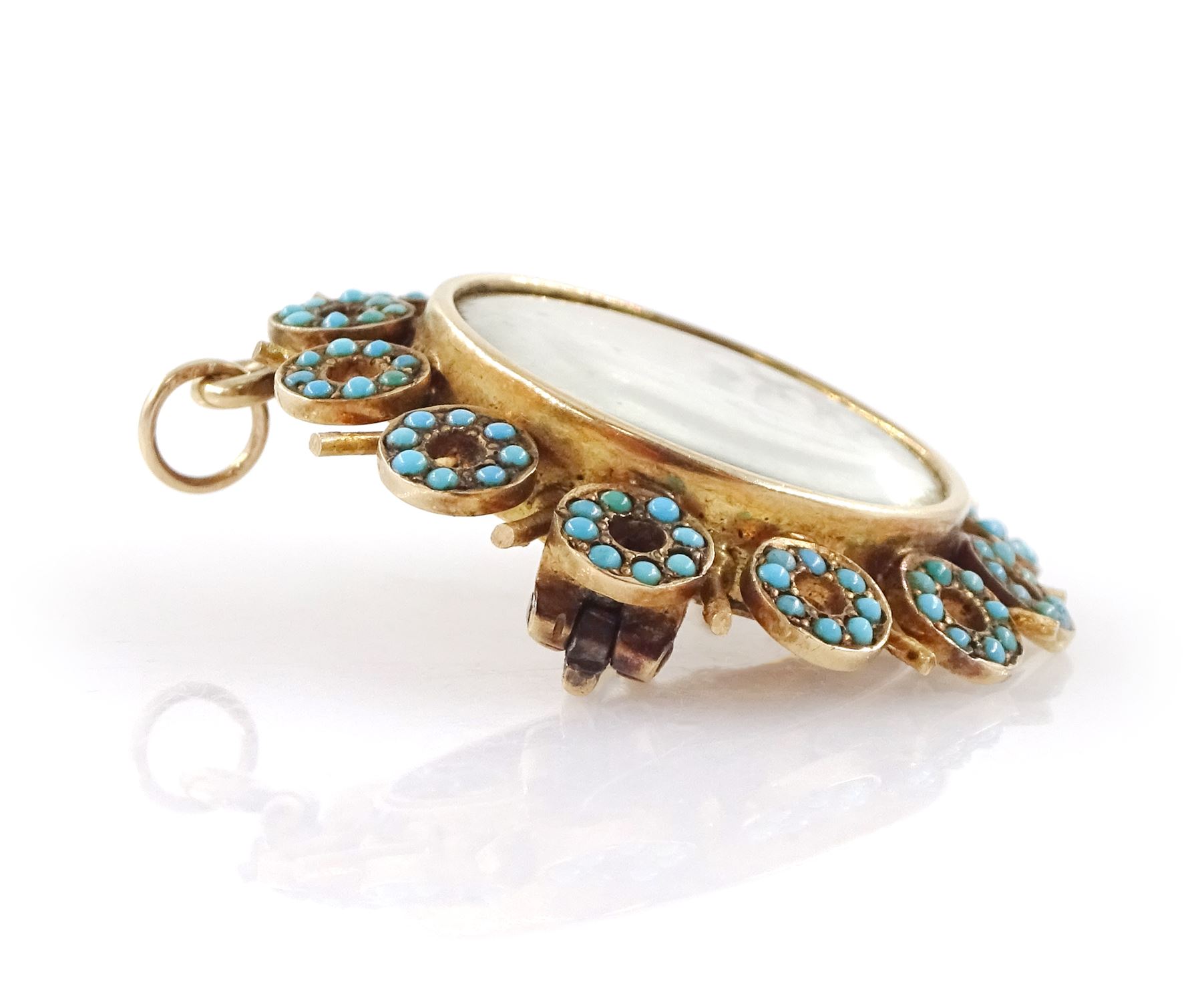 19th century gold turquoise portrait brooch / pendant, set with a circular portrait of a woman in 18th century dress on ivory, under a glazed panel, within an alternating surround of turquoise set hoops and gold spokes. This lot has been registered for sale under Section 10 of the APHA Ivory Act