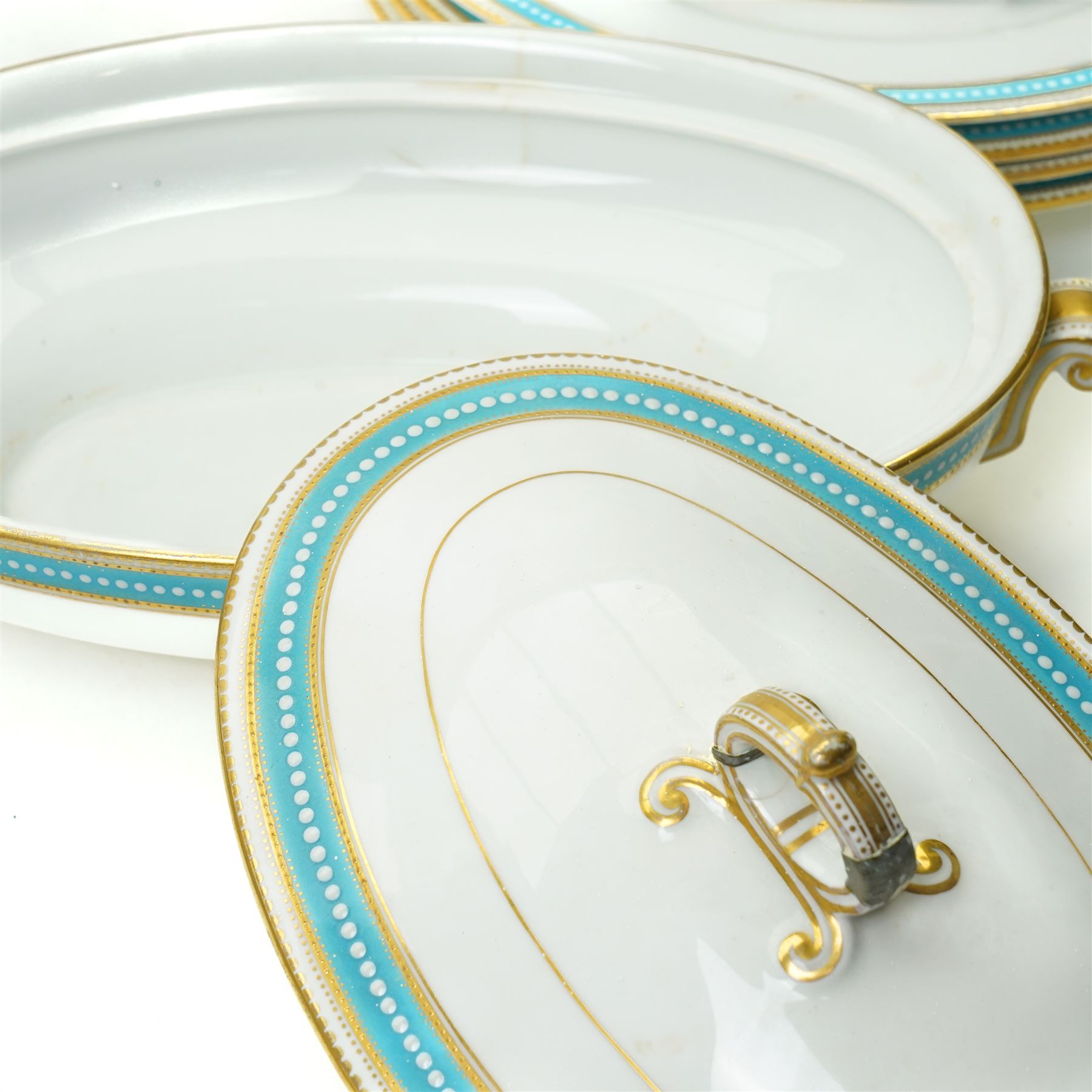 Spode Copeland's china part dinner service, circa 1900, with a blue and gilt jewelled border comprising ten dinner plates, seven dessert plates, two side plates, pair of vegetable dishes and covers, two sauce tureen stands and oval meat plate retailed by T Goode, London