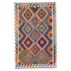 Afghan kilim multicoloured rug, the geometric field decorated with repeating lozenges of c...