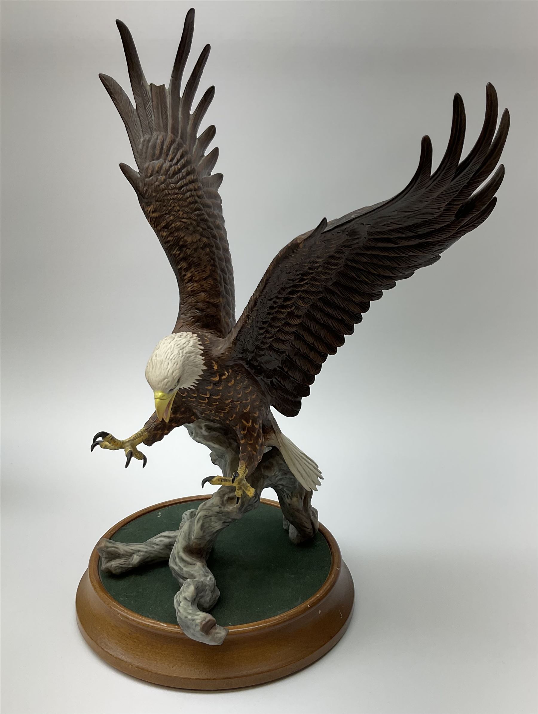 Three Franklin Mint figures, first example On The Prowl, on wooden stand H32cm, L63.5cm, Grizzly, H23cm and American Majesty by Ronald Van Ruyckevelt H37cm, together with five other figures.  