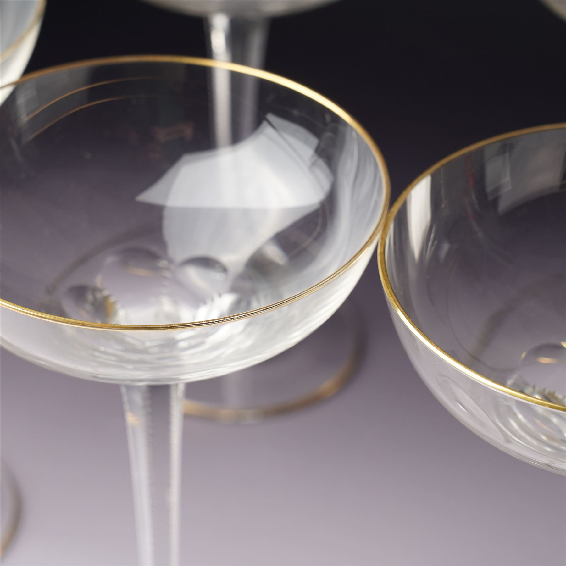 Set of six Wiener Werkstatte champagne coupe glasses, with gilt trimmed rim and foot, the faceted trumpet stem with toothed edges, H17cm 