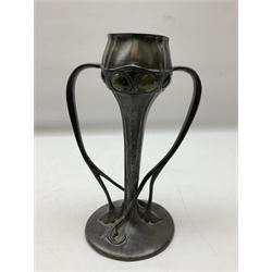 Archibald Knox (1864-1933) for Liberty & Co, Tudric pewter tulip vase, with green cabochons decorating a bulbous bowl upon a tapering stem leading to a spreading foot issuing twin tendril handles that rise to meet the bowl, stamped beneath 029, H24cm
