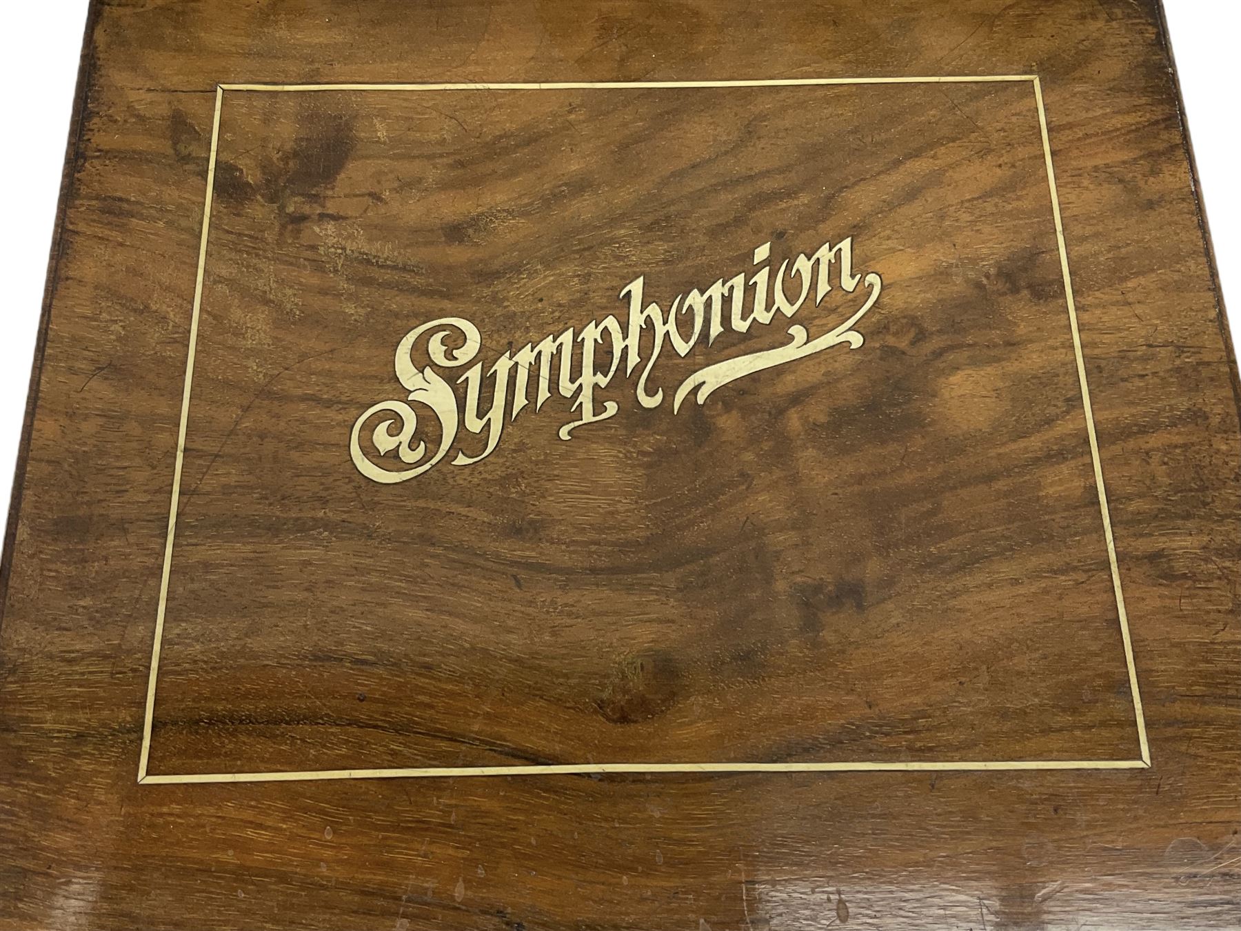 Late 19th century Symphonion disc musical box in inlaid walnut case with front lever action playing 25.5cm discs on a 10.5cm steel comb with forty-nine teeth, musical scene of cherubs under the lid, L33cm; together with five 25.5cm discs, fifteen 20.5cm discs and eleven 19cm discs
