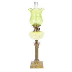 Green glass and brass oil lamps, with frilled glass shade, reservoir decorated with flower...