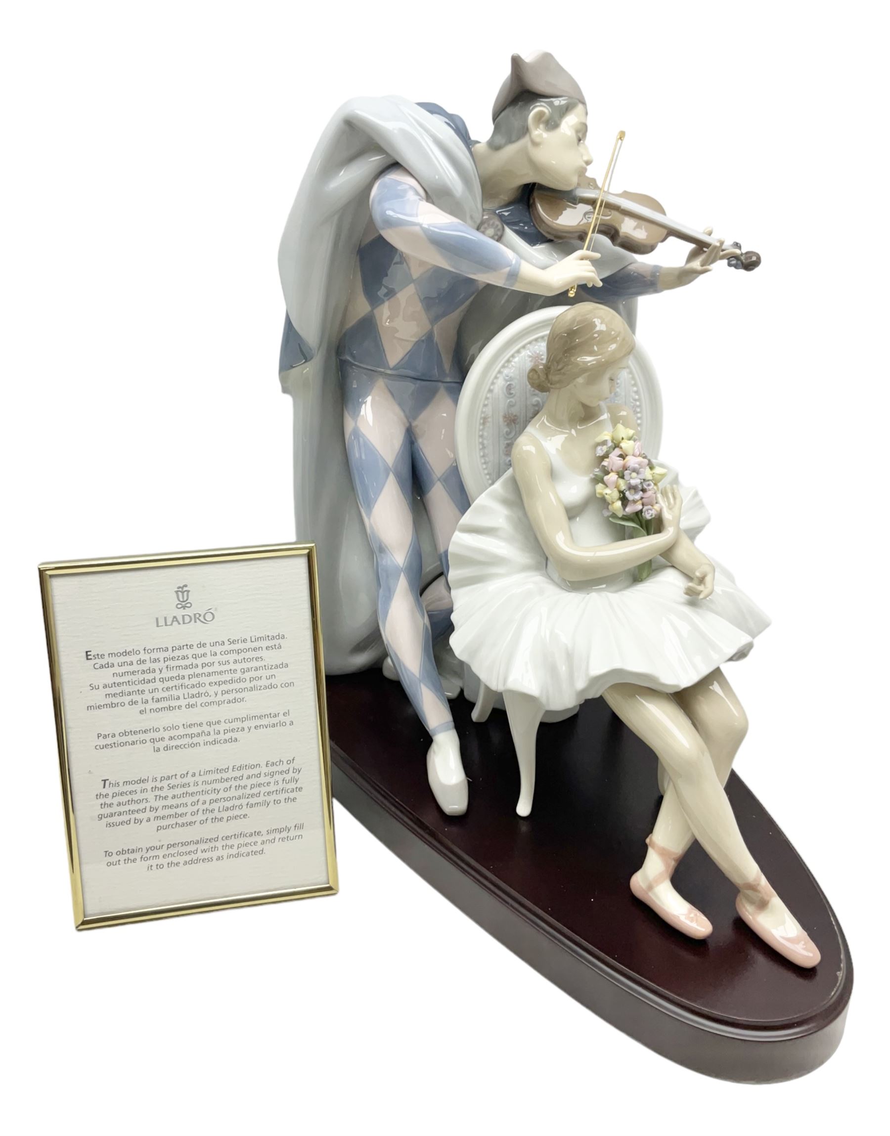 Lladro figure, Jester Serenade, modelled as a ballerina with bouquet of flowers seated before a jester playing the violin, limited edition 2541/3000, sculpted by Antonio Ramos, no 5932, with original box, year issued 1993, year retired 1994, H37cm