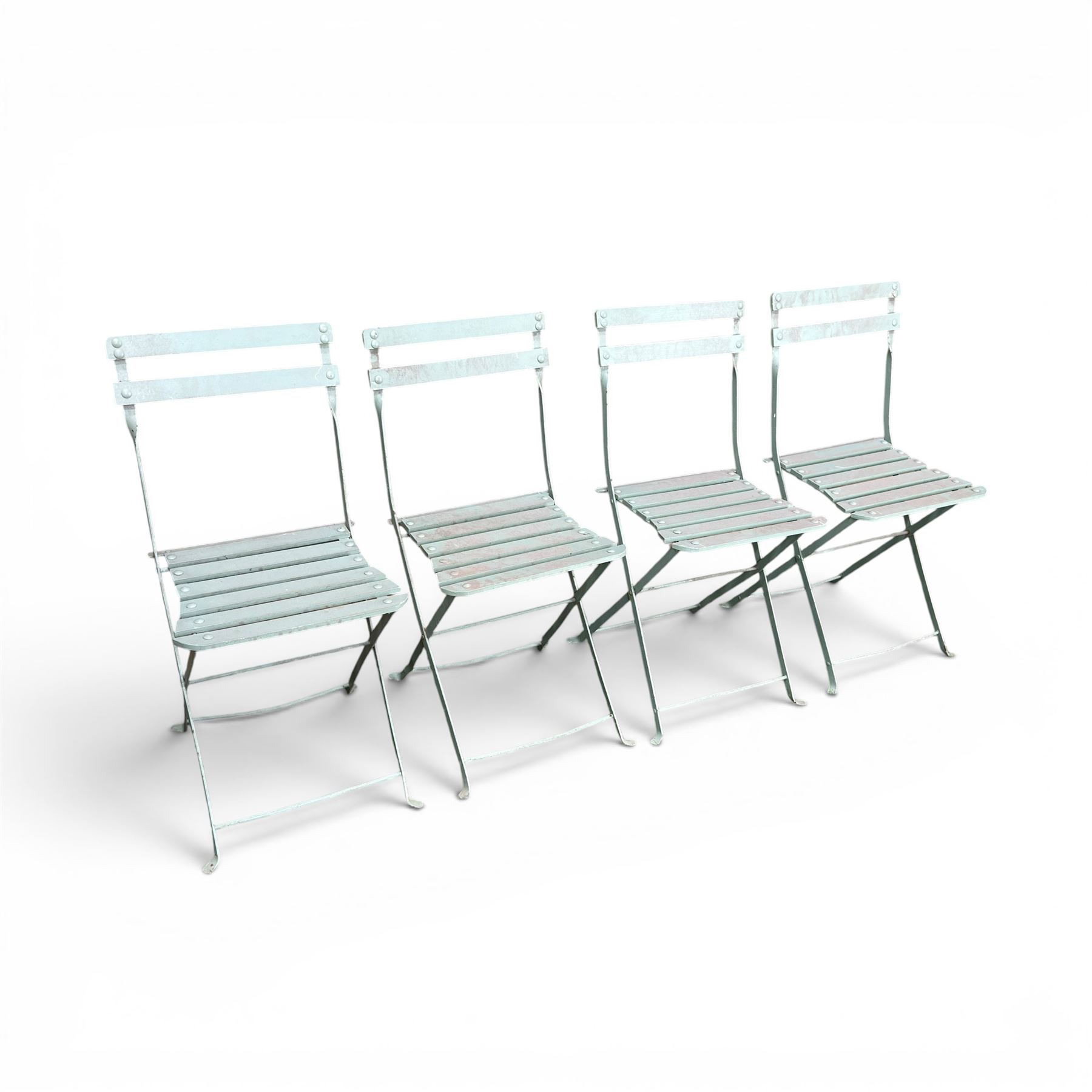 Wrought metal folding garden table, with painted wood plank top; and four matching folding chairs