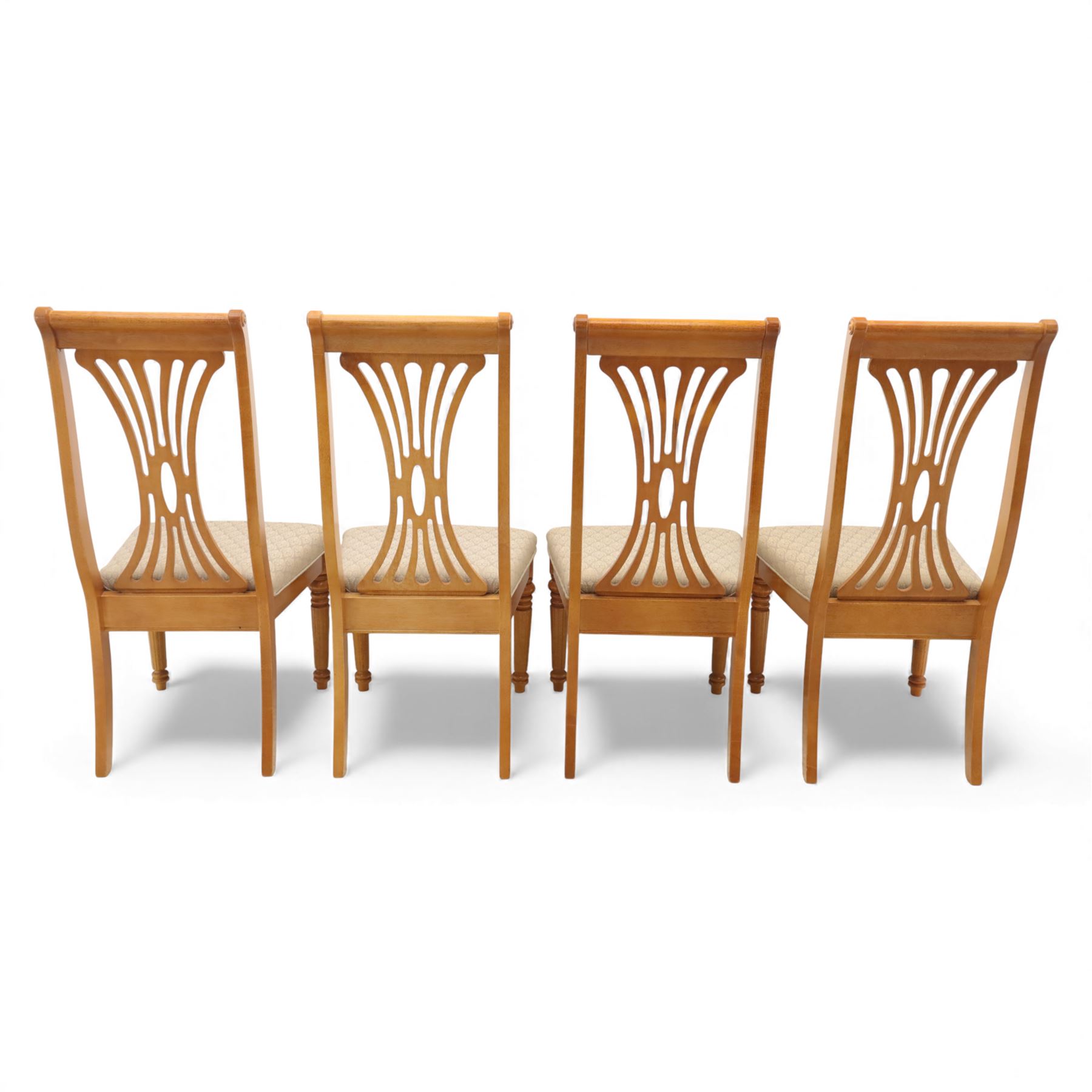 Late 20th century parquetry veneered extending dining table and eight chairs, the rectangular top with canted corners decorated with geometric parquetry panels, moulded edge frieze with repeating carved detail, raised on twin pedestal supports with fluted columns and shaped platform bases, the chairs with pierced splat backs and upholstered drop-in seats
Extends on a central leaf to 208cm