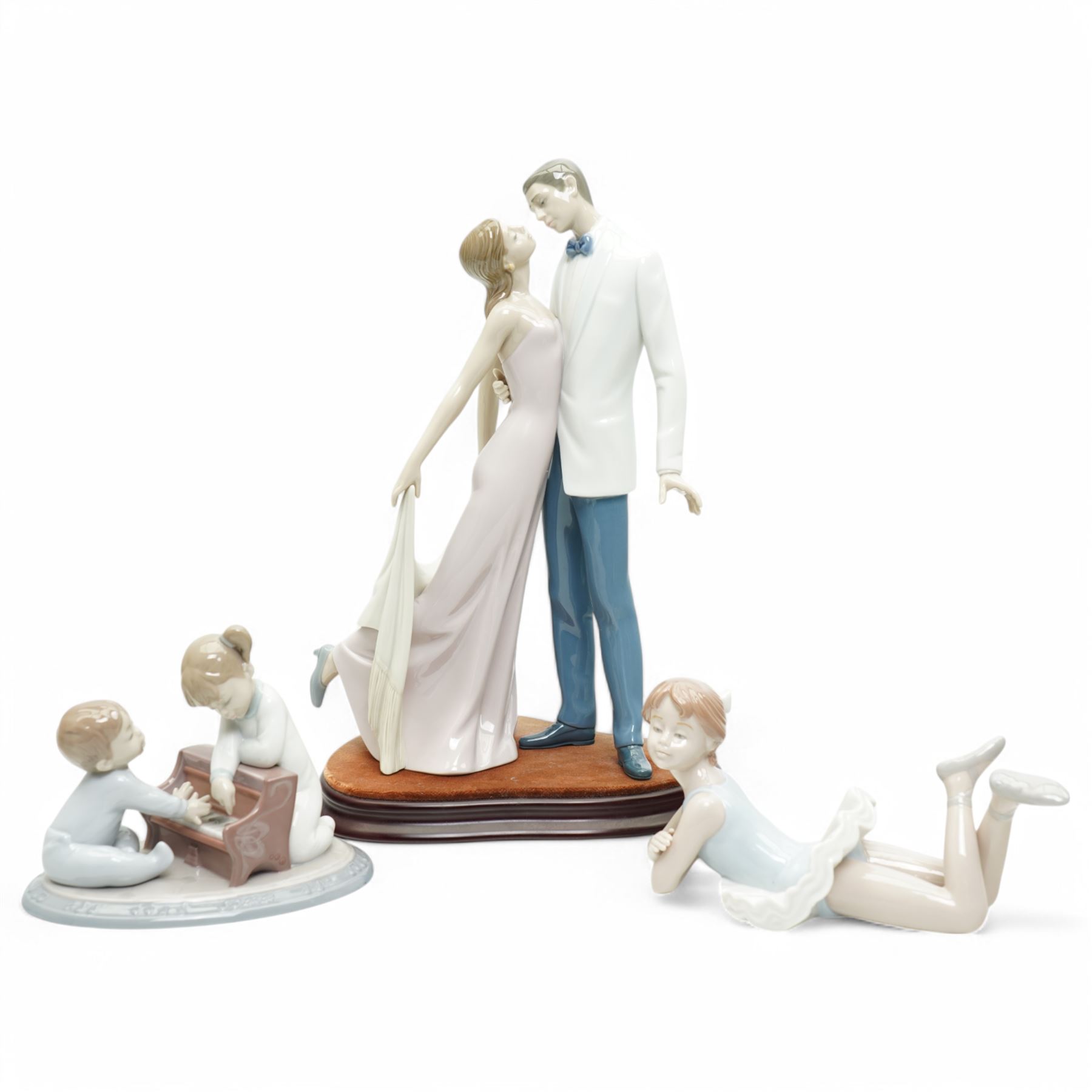 Two Lladro figures, comprising First Melodies 6475 and Happy Anniversary 8292, with one Nadal ballerina, all boxed, tallest H31cm excluding base (3)