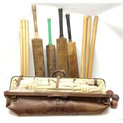 A Vintage leather cricket bag and equipment, to include cricket bats, balls, wickets, and pads. 