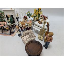 Dolls house furniture, including pianos, fireplace, plants, flower arrangements, tables, chairs, six figures and a collection of instruments and other accessories