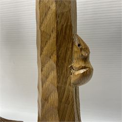 Mouseman - pair of tooled oak candlesticks, wrought iron sconce with drip tray over tapered octagonal column carved with mouse signature, terminating to stylised leaf carved square base, by the workshop of Robert Thompson, Kilburn
