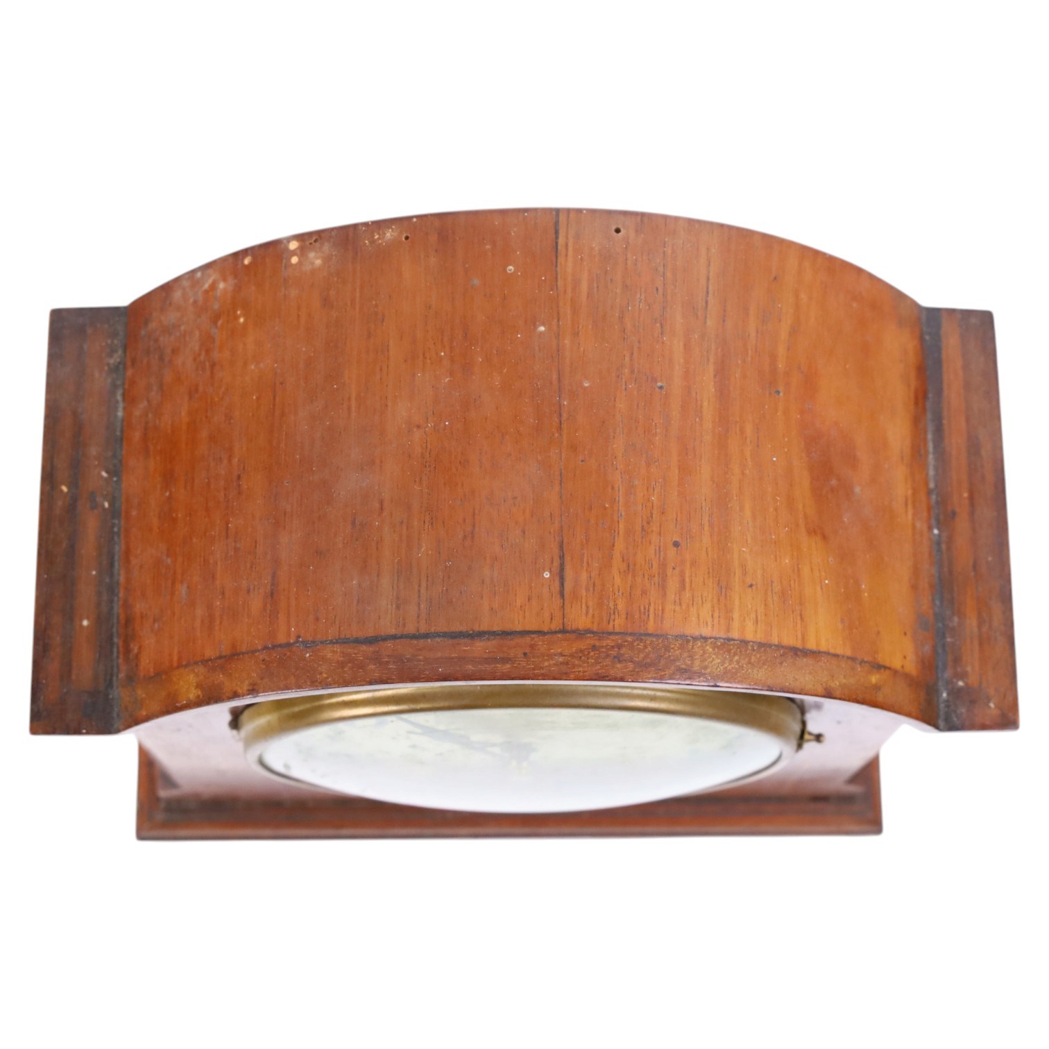 Gilbert Clock Company eight-day mahogany cased mantle clock, with a cream card dial, break arch top, upon a raised plinth, H28cm