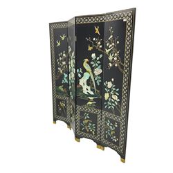 Japanese Shibayama style black lacquered four panel folding screen, naturalist scenes of trailing branch and blossom flowers, decorated with with birds, floral mother of pearl inlaid borders