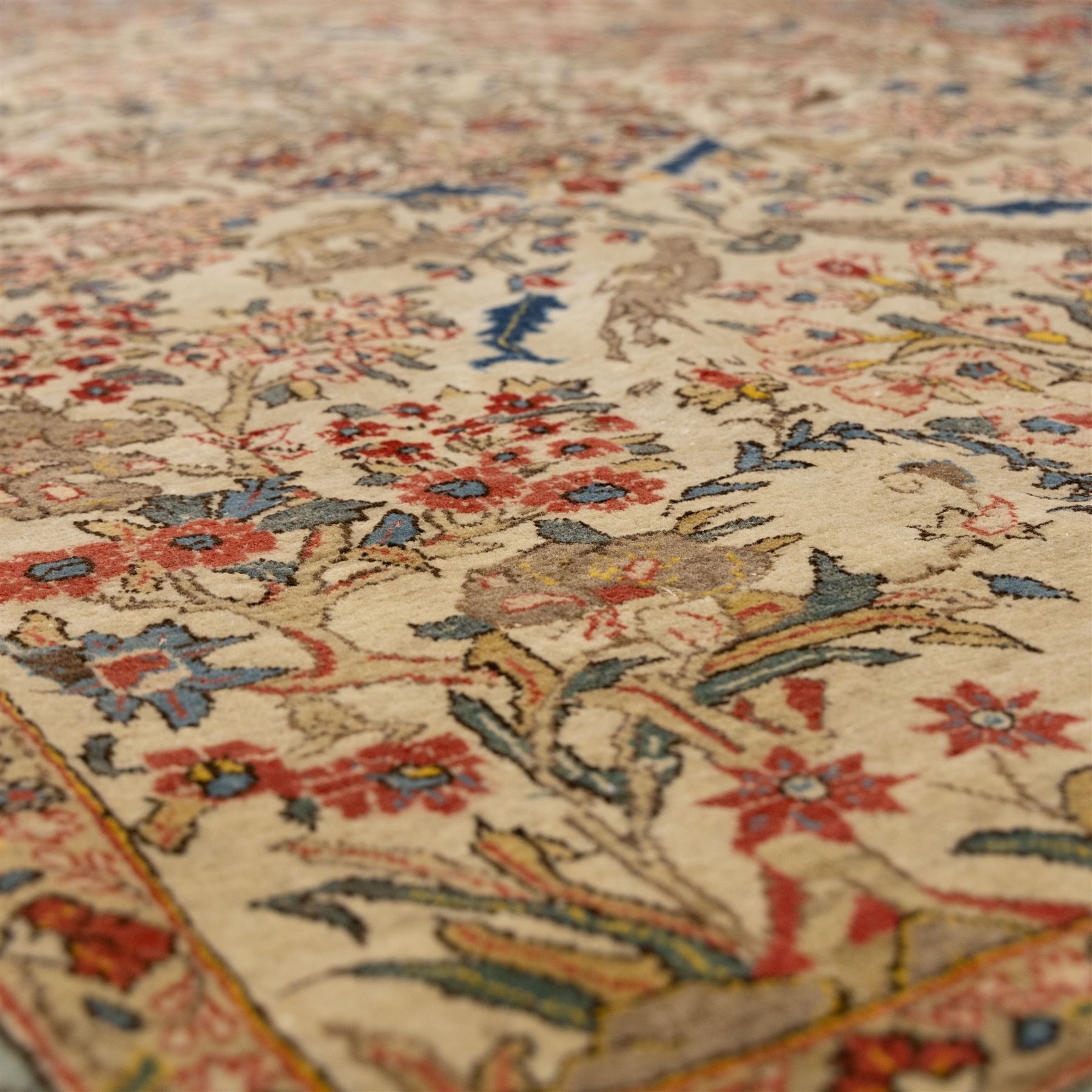 Persian pictorial Kashan rug, ivory field woven with a central tree of life surrounded by flowering plants, birds, and animals, enclosed by a broad turquoise border with scrolling foliage and palmettes